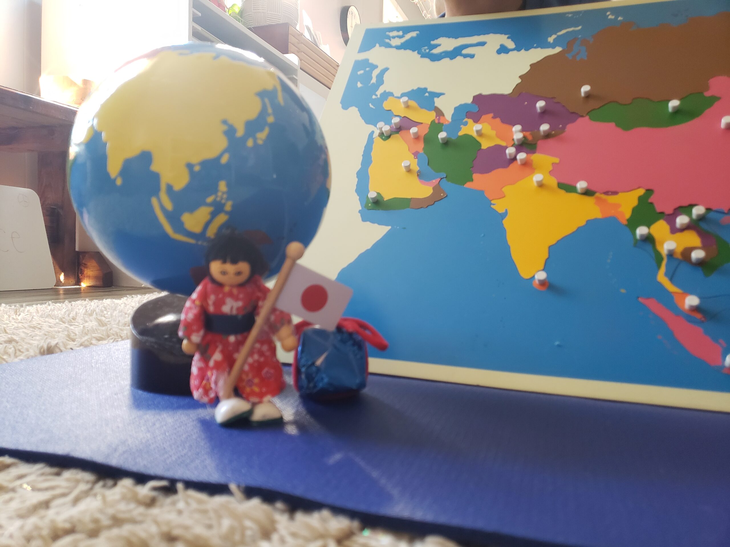 A toy doll Japanese woman and a globe