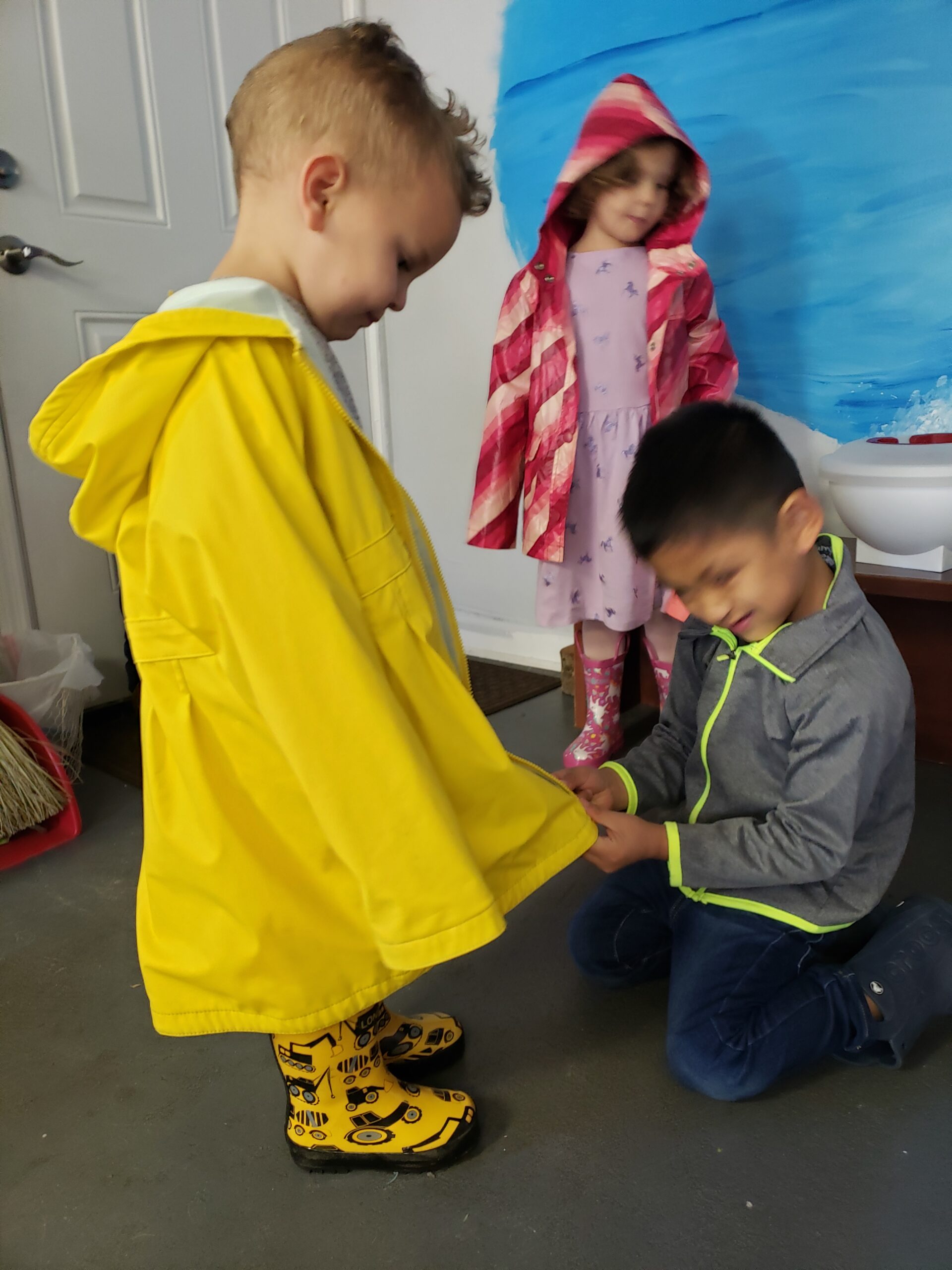 Kids putting on their rain coats